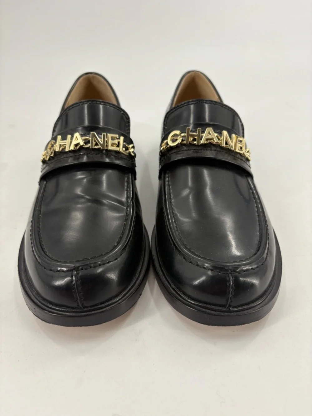 CHANEL Black Leather Loafers with Gold Logo Chain